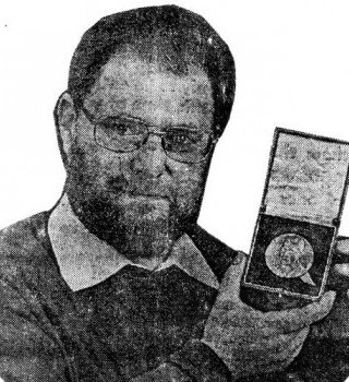 Harry Ford, showing the Lorimer medal.