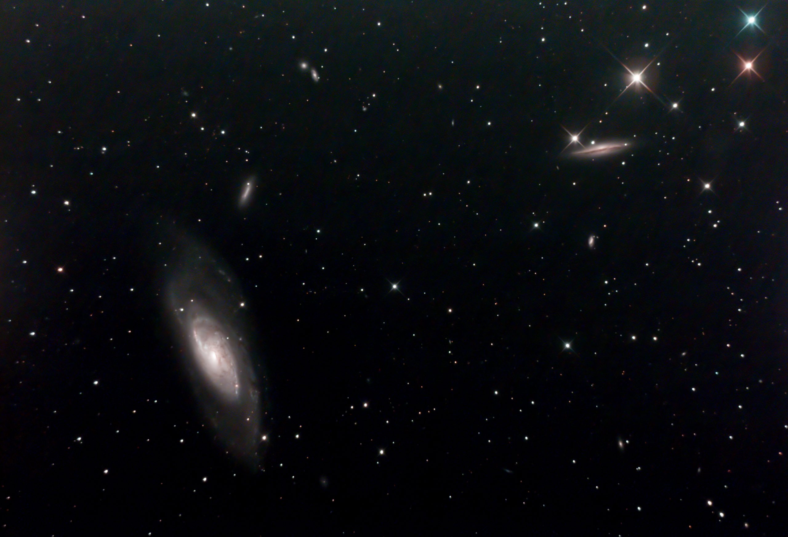 M106 Et Al (Ian A Smith) M106 and at least 8 neighbouring (on sky) galaxies such as NGC 4217, NGC 4248, NGC 4226, NGC 4232 and NGC 4231 . Skywatcher 200p on NEQ6 mount, with guiding and dithering. Canon 100d modified DSLR with Optolong CLS-CCD filter. 37 five minute exposures at ISO 800 (3 hours 5 minutes), 5 dark frames, 10 flat fields, 14 bias frames. 24th April 2020. Overnight temperatures were a bit higher than winter, leading to more noise in the image. Worth a return visit!