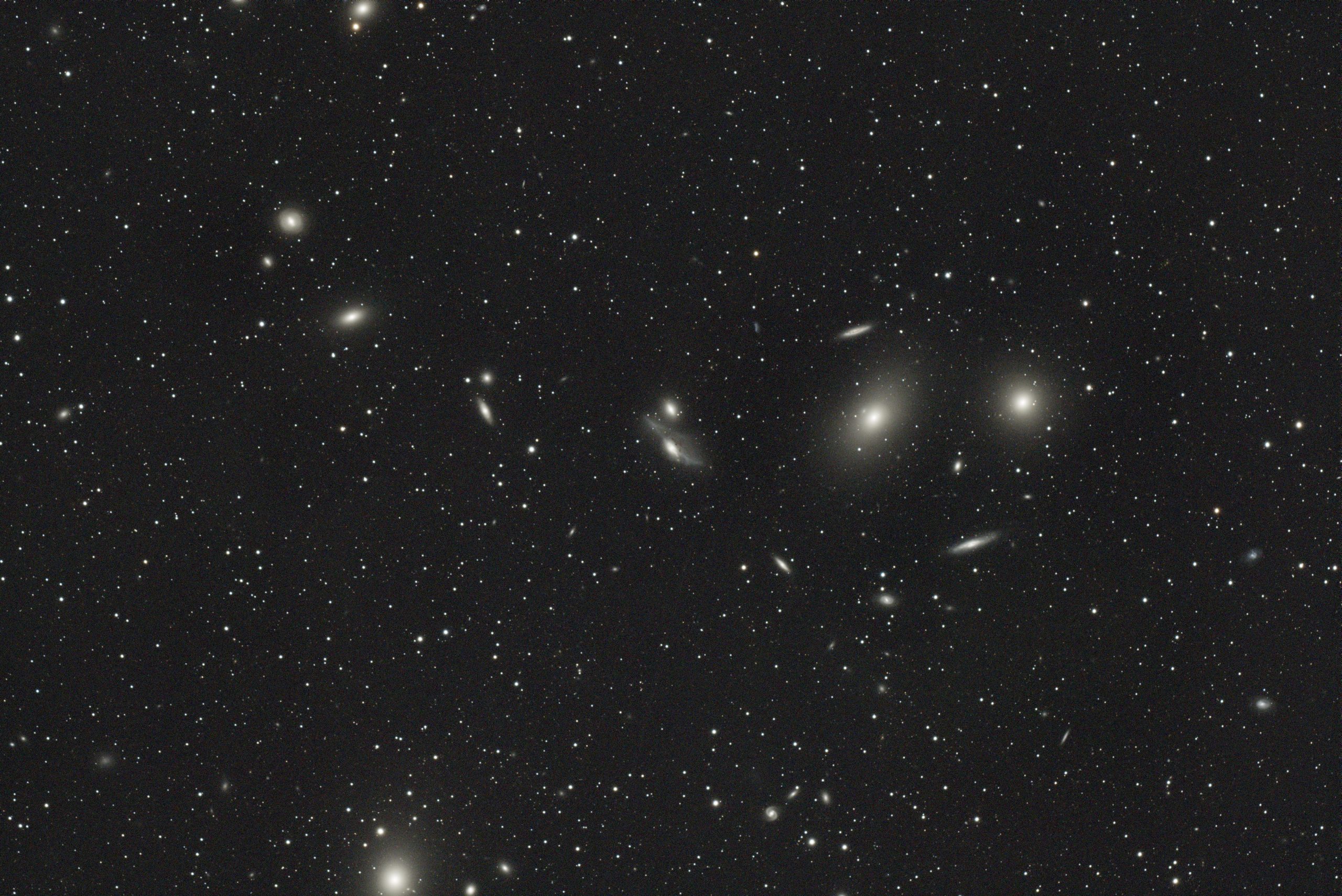 Markarian's Chain (Ramsay) A string of galaxies in the Virgo cluster named after the Armenian astrophysicist, Benjamin Markarian, who discovered their common motion in the early 1960s. Included in this picture are: NGC 4374 - M84 discovered by Charles Messier in 1781 NGC 4388 NGC 4402 NGC 4406 - M86 also discovered in 1781 by Messier NGC 4407 NGC 4425 NGC 4438 NGC 4459 NGC4461 NGC 4473 NGC 4477 NGC 4486 - M87 aka Virgo Galaxy also discovered in 1781 23/04/2022 started 00:14 9 x 5 minute exposures plus bias, flats, darks and dark flats Scope: Takahashi FSQ-106ED @ f5.0 Mount: iOptron CEM40 Camera: ASI2600MC -20°C ASIAIR Pro PixInsight, Photoshop